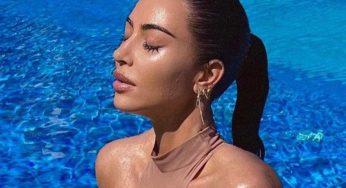 Kim Kardashian Soaks Up The Sun In Skin-Tight One Piece Swimsuit